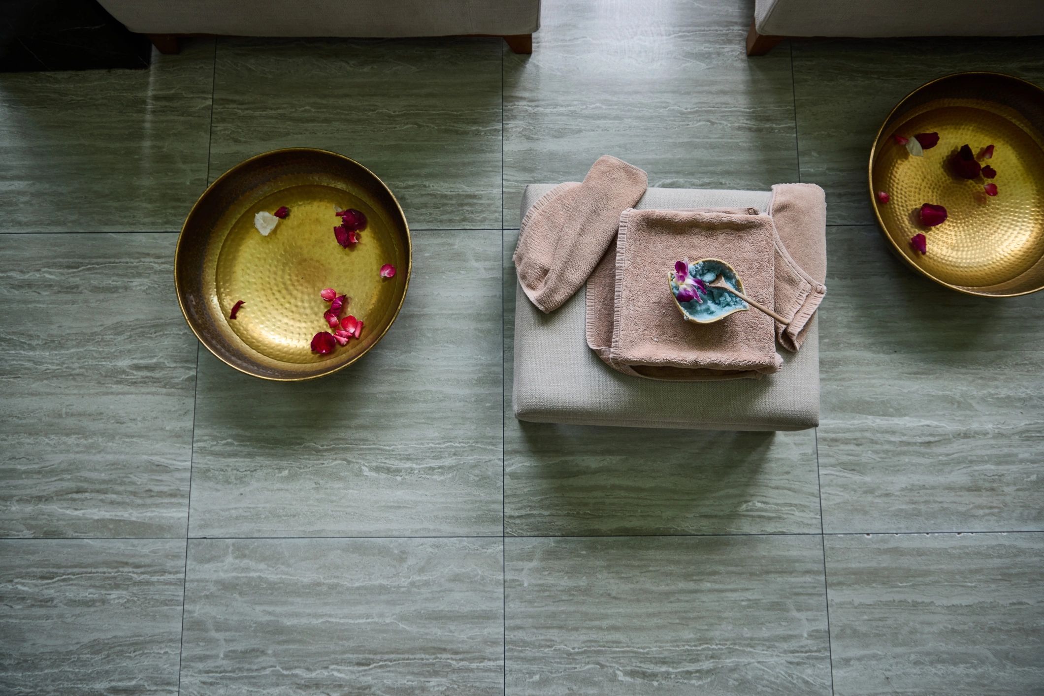 Relaxing spa setting with towels and rose petals